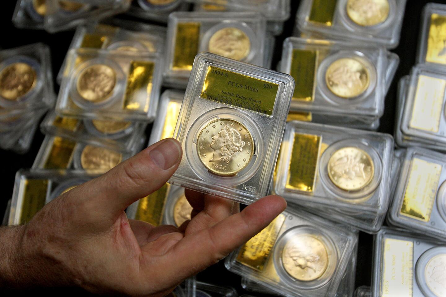 Some of 1,427 Gold Rush-era U.S. gold coins found buried in the Salinas Valley are displayed at Professional Coin Grading Service in Santa Ana.