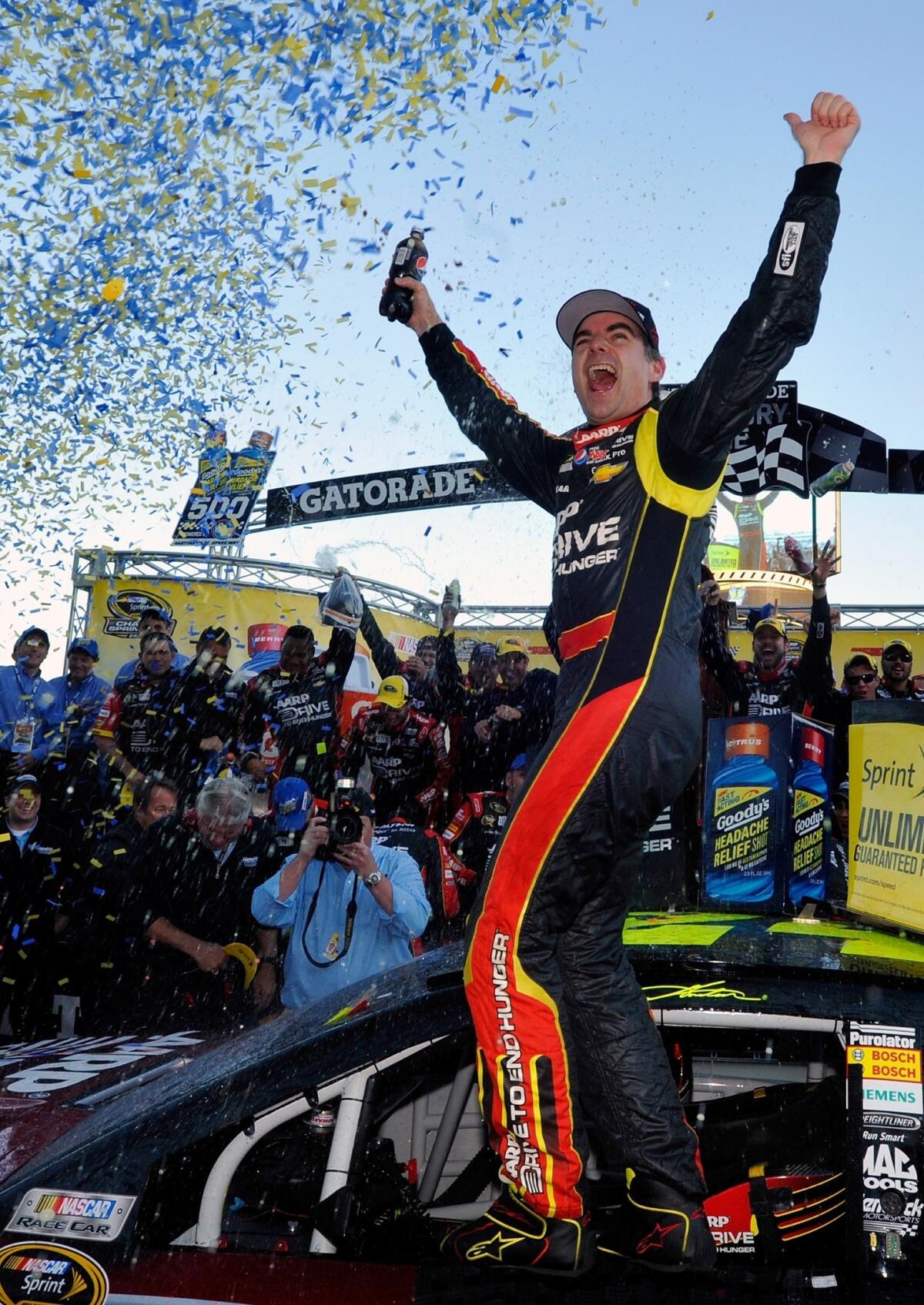 Jeff Gordon celebrates after winning Sunday's NASCAR Sprint Cup race at Martinsville Speedway.