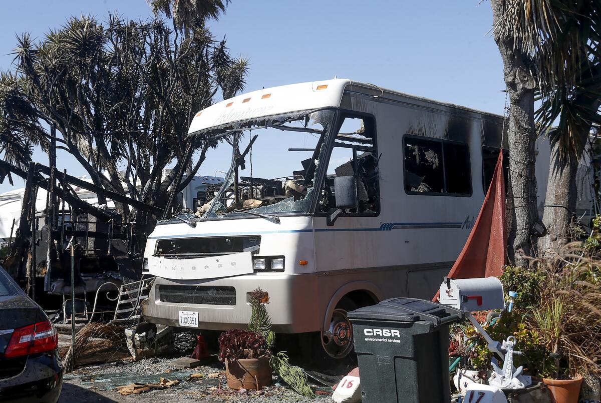 A Winnebago RV destroyed by a fire in a trailer park.