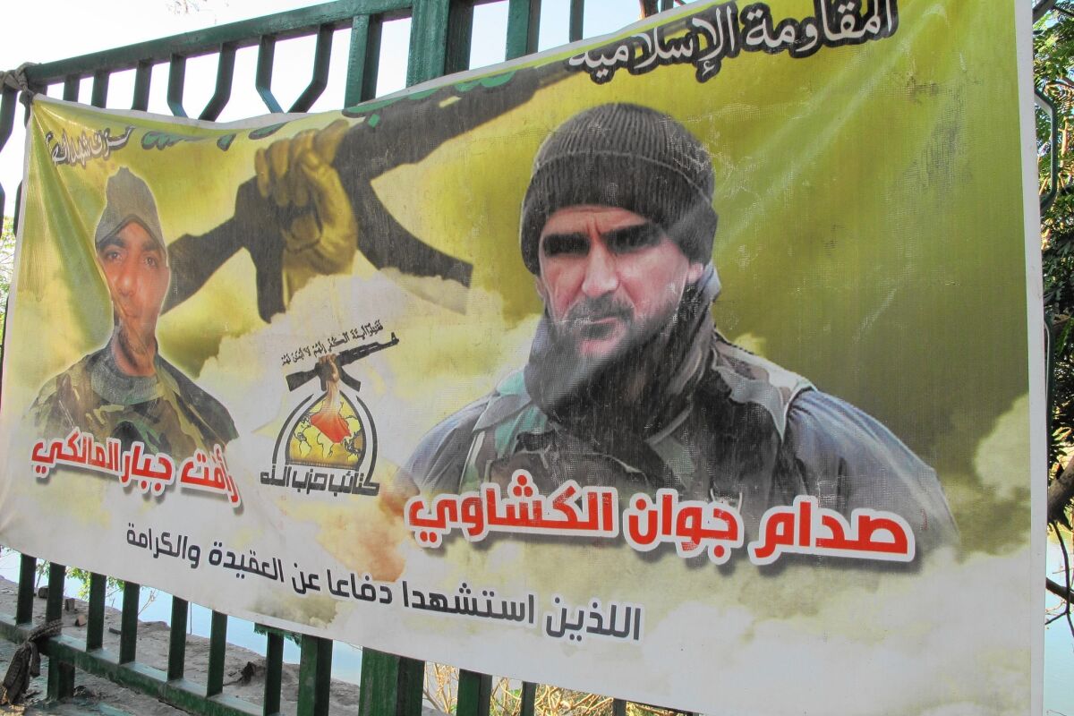 A banner in Baghdad commemorates two Shiite Muslim militia members slain in battle.