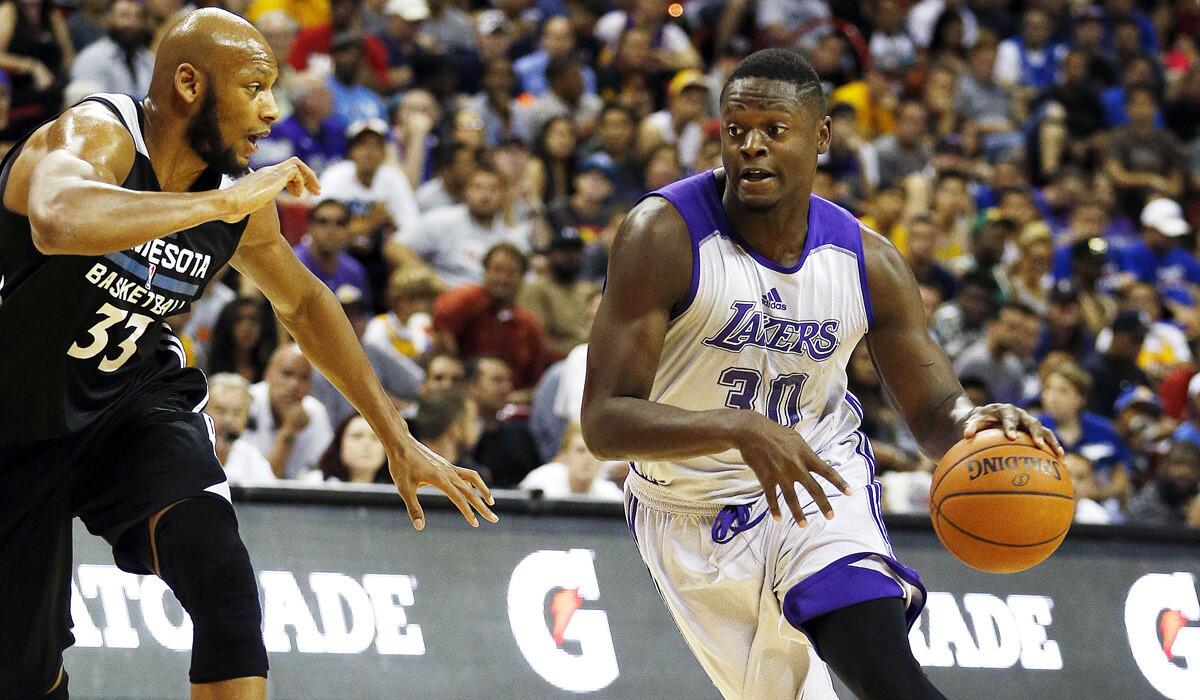 Lakers forward Julius Randle drives against Timberwolves forward Adreian Payne during the first half of an NBA summer league game in Las Vegas.