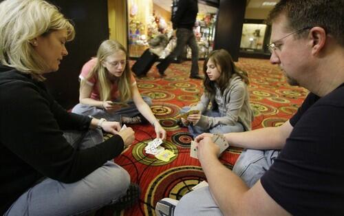 Family plays cards at the O'Hare Hilton while stuck in travel