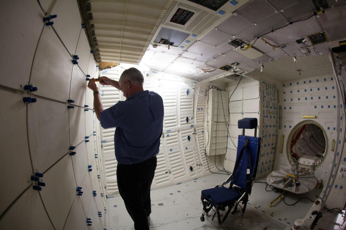 Jenkins opens a compartment inside the mid-deck of Endeavour. Even before the shuttles flew their final missions in 2011, institutions across the country began jockeying to get one of the four orbiters NASA would give away.
