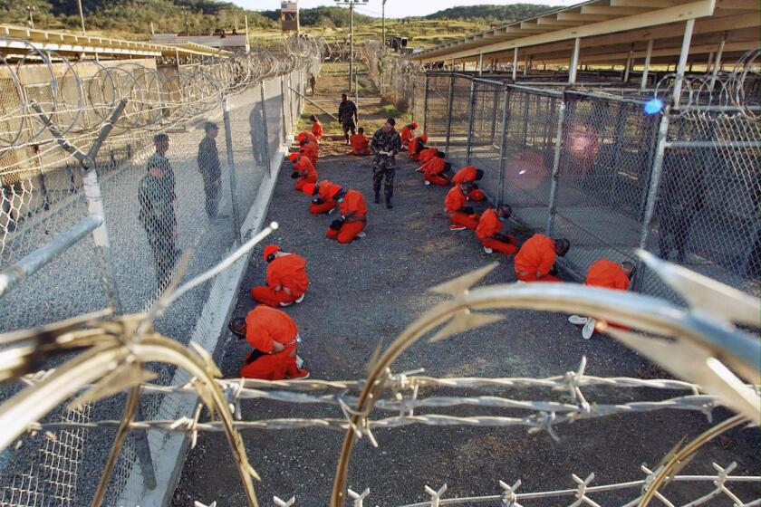 1/2002 FILE - SUBJECT: WAR ON TERRORISM - (NYT36) GUANTANAMO BAY, Cuba -- June 20, 2004 -- GUANTANAMO-DETAIN-4 -- Detainees from Afghanistan at Camp X-Ray, the first makeshift prison at the Guantanamo Bay Naval Station, in January 2002. The base now has other detention facilities. As the Supreme Court prepares to rule on the legal status of the 595 men imprisoned in Guantanamo Bay, Cuba, an examination by The New York Times has found that government and military officials have repeatedly exaggerated both the danger of the detainees posed and the intelligence they have provided. KEYWORDS: POW. PRISONS. TERRORISM. USA. WAR. (Department of Defense/The New York Times)