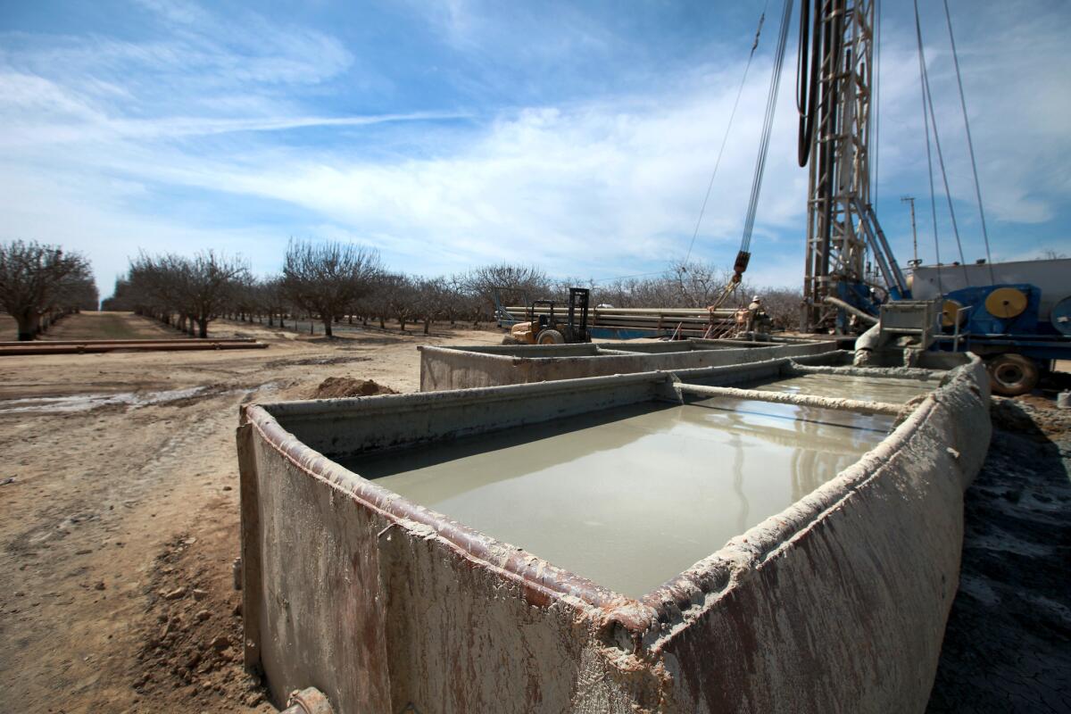 Fracking fluids flow into containment tanks on a fracked oil well near Bakersfield in March.