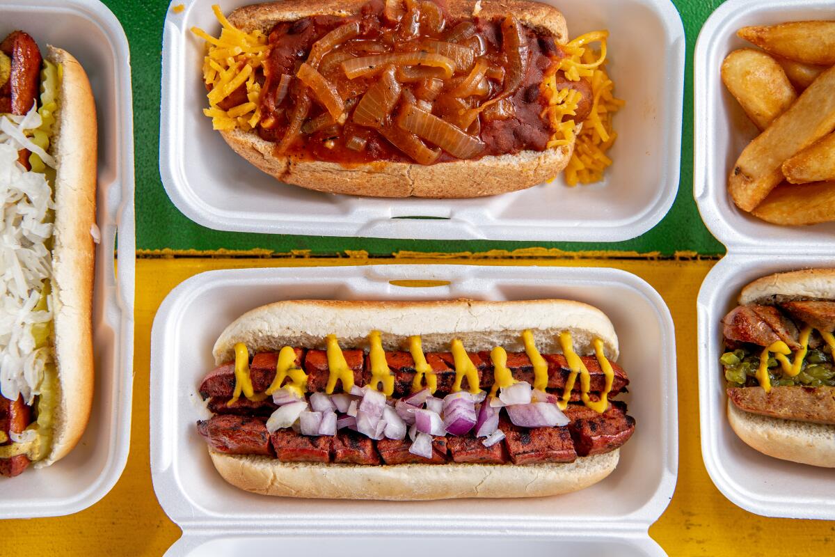 LOS ANGELES, CA - NOVEMBER 03: **styrofoam used for photo purpose only-not normally served like this. Must be put in photo caption if used** clockwise from left: Chicken link, vegan dog with vegan chili, kosher beef jumbo and the beef link from Earle's On Crenshaw on Friday, Nov. 3, 2023 in Los Angeles, CA. (Mariah Tauger / Los Angeles Times)