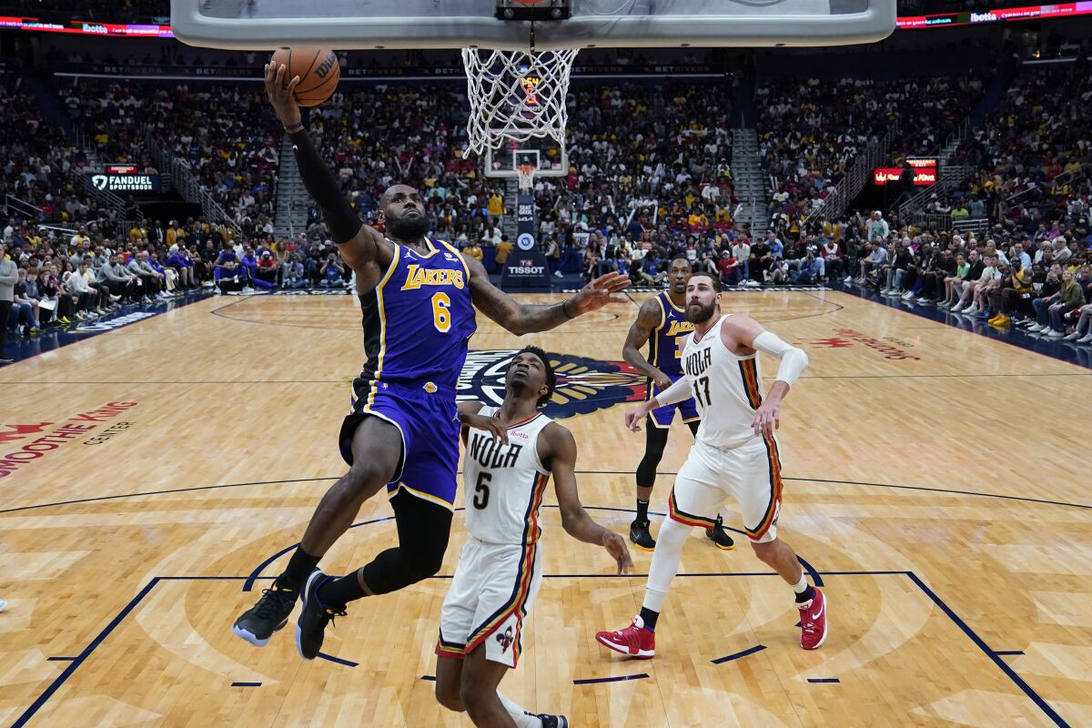 Lakers star LeBron James scores over New Orleans Pelicans forward Herbert Jones.