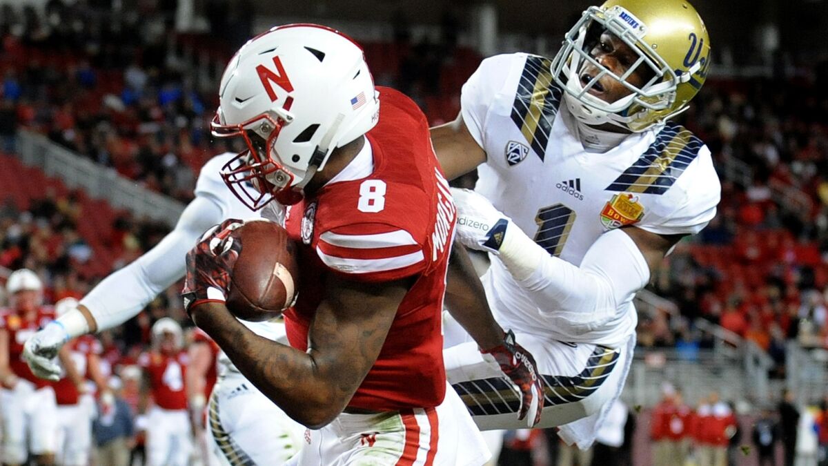 Nebraska receiver Stanley Morgan Jr. makes a one-handed catch for a touchdown against UCLA cornerback Ishmael Adams in the third quarter during the Foster Farms Bowl on Dec. 26.