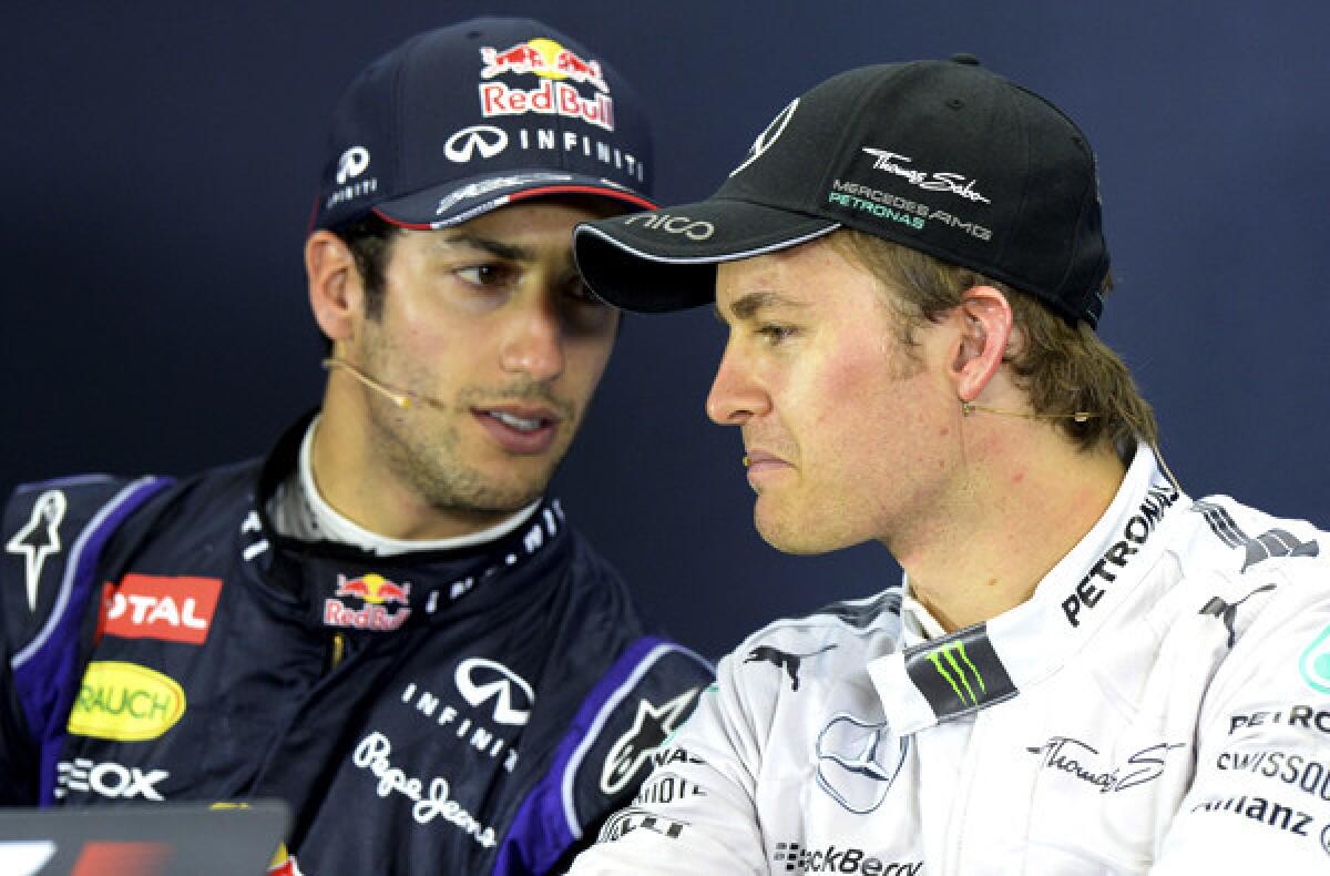 Red Bull driver Daniel Ricciardo and Mercedes driver Nico Rosberg, who won the Australian Grand Prix on Sunday, chat during a news conference before Ricciardo was disqualified as the runner-up.