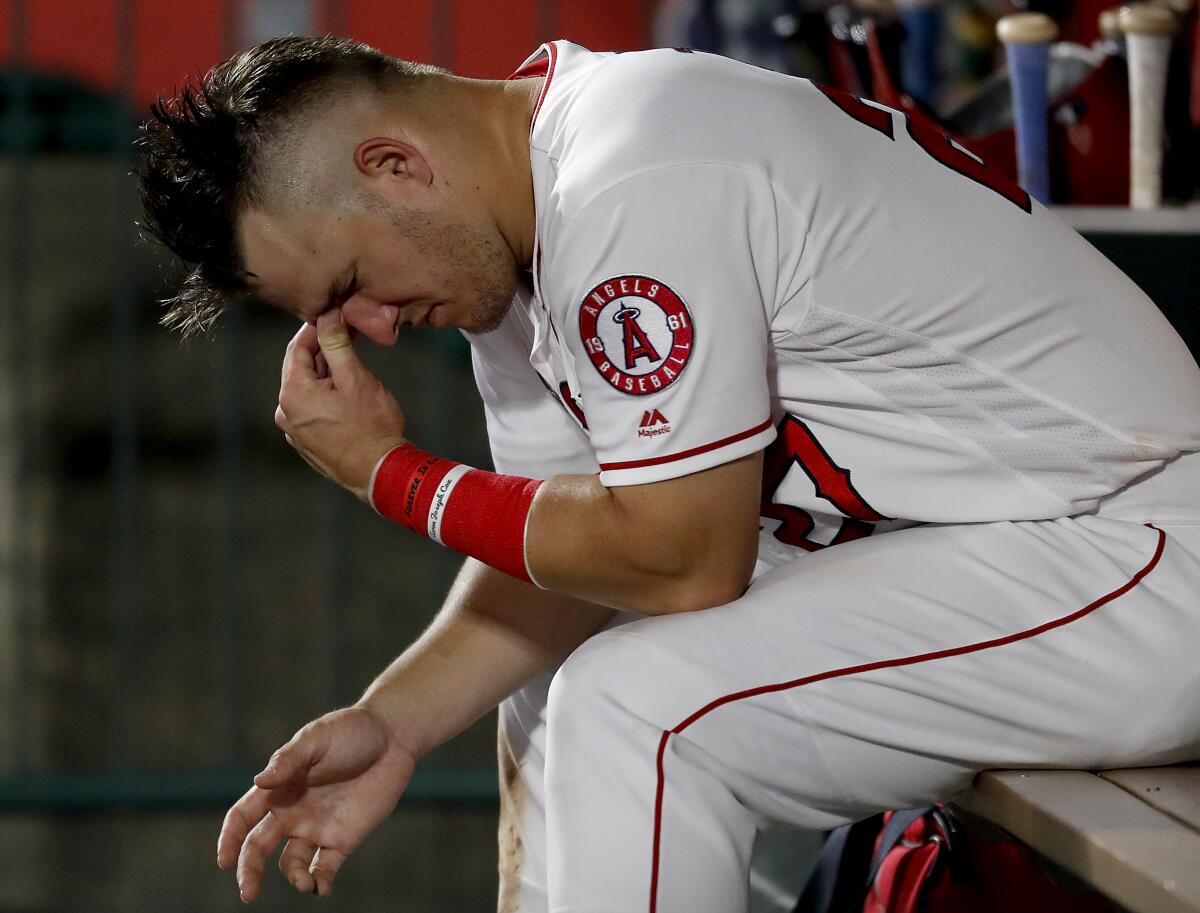 Angels star Mike Trout reacts in the dugout during a loss Aug. 13, 2019.