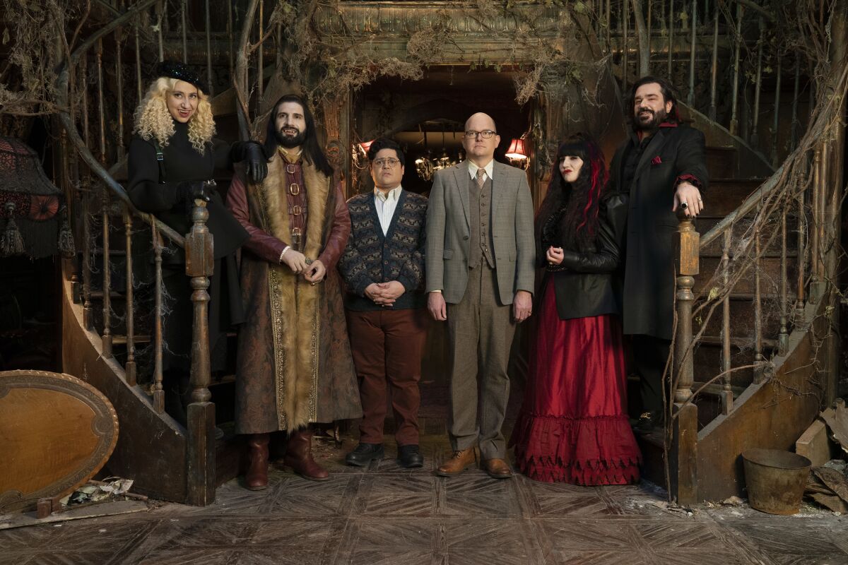 The cast of "What We Do in the Shadows" poses for a portrait on set.