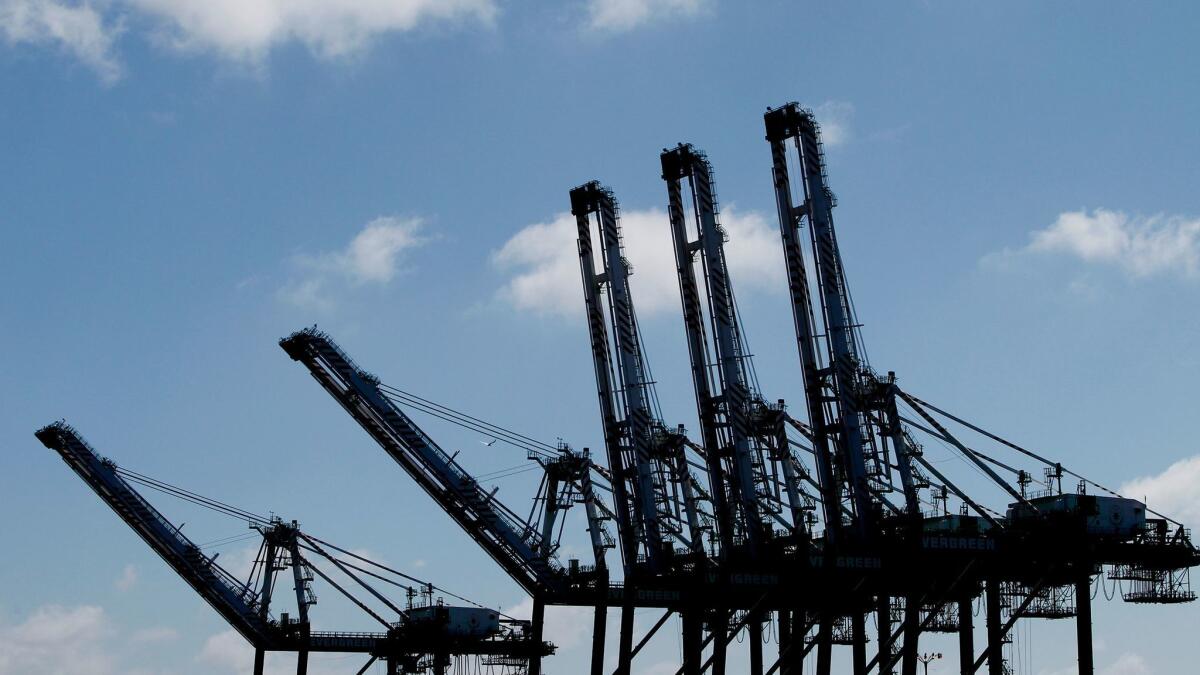 Giant cranes stand ready in the Port of Los Angeles to load and unload container vessels.