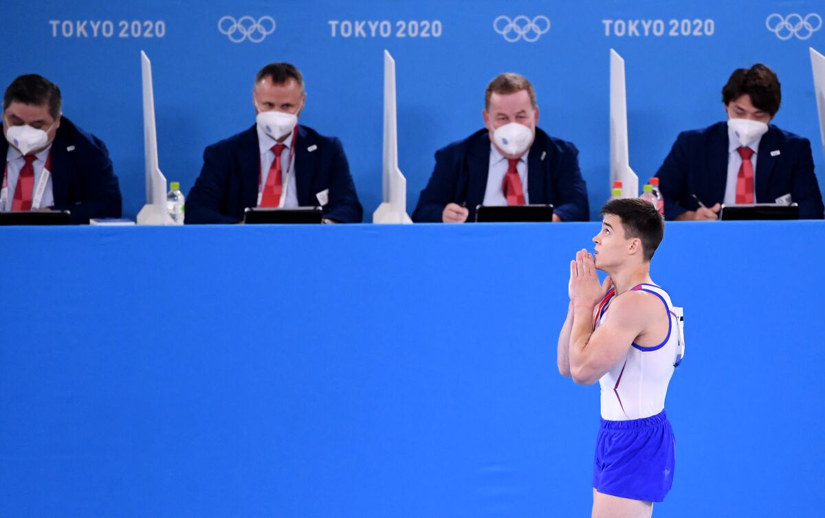 Russia Olympic Committee's Nikita Nagornyy gestures as he walks past the judges table.