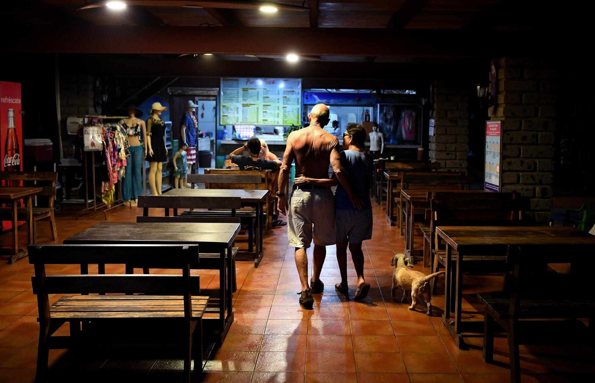 Bob Rotherham and his wife Marta walk in the dining area of their hotel
