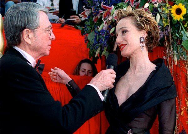 British actress Kristin Scott-Thomas talks with television host Army Archer, left, in 1997 as she arrives for the 69th annual Academy Awards.