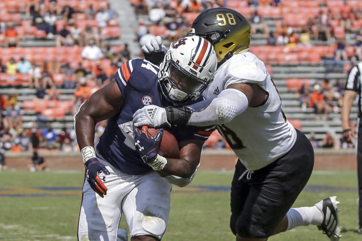 Auburn running back Sean Jackson (44) caries the ball in for a touchdown as Alabama State lineman Joshua Long (98) defends during the second half of an NCAA football game Saturday, Sept. 11, 2021, in Auburn, Ala. (AP Photo/Butch Dill)