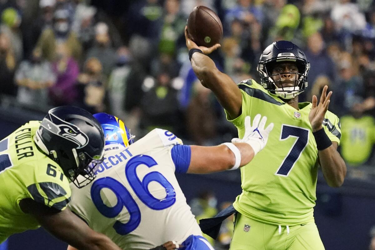 Seattle Seahawks backup quarterback Geno Smith passes to wide receiver DK Metcalf.