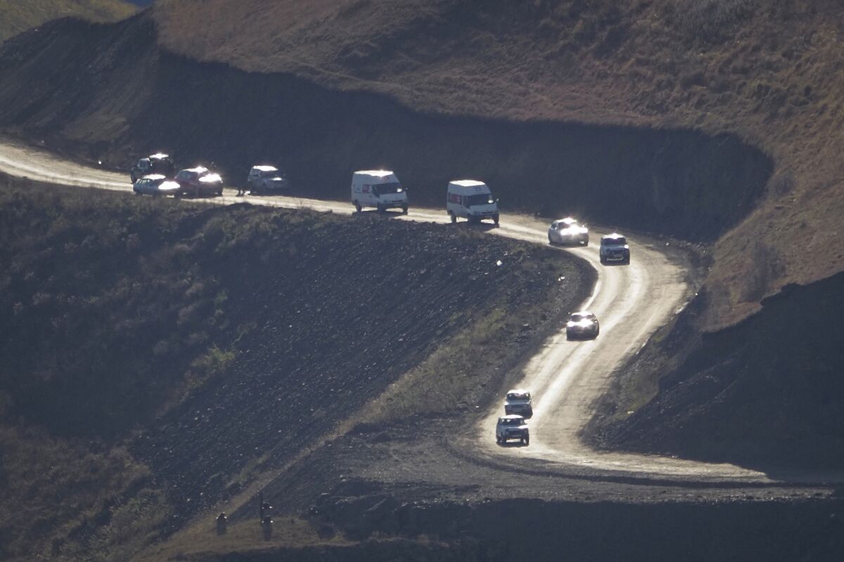 Motorists leaving the separatist region of Nagorno-Karabakh approach the border of Armenia on Sunday.