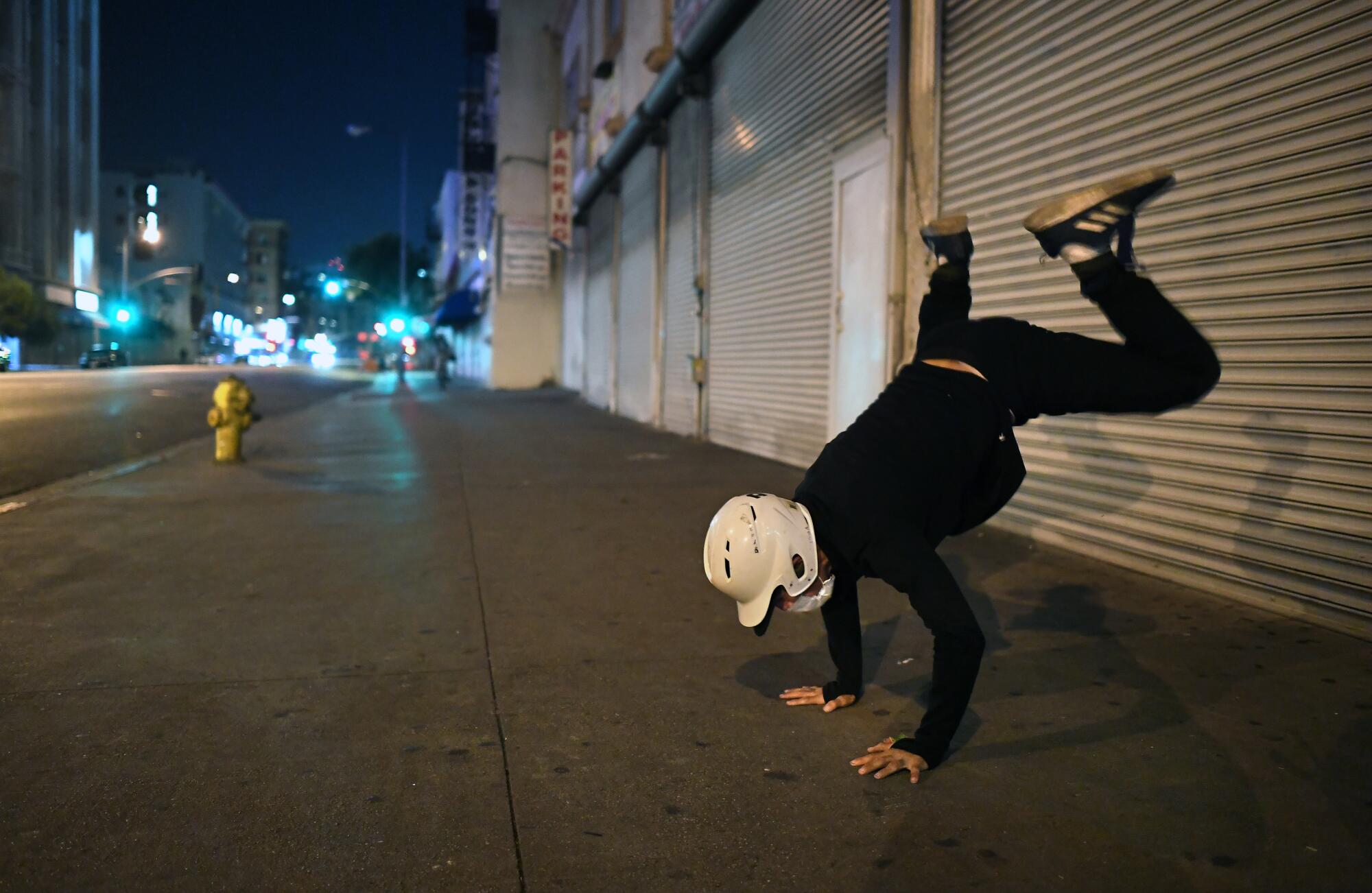 Aspiring break dancer Bobby Estrada practices along Los Angeles Street