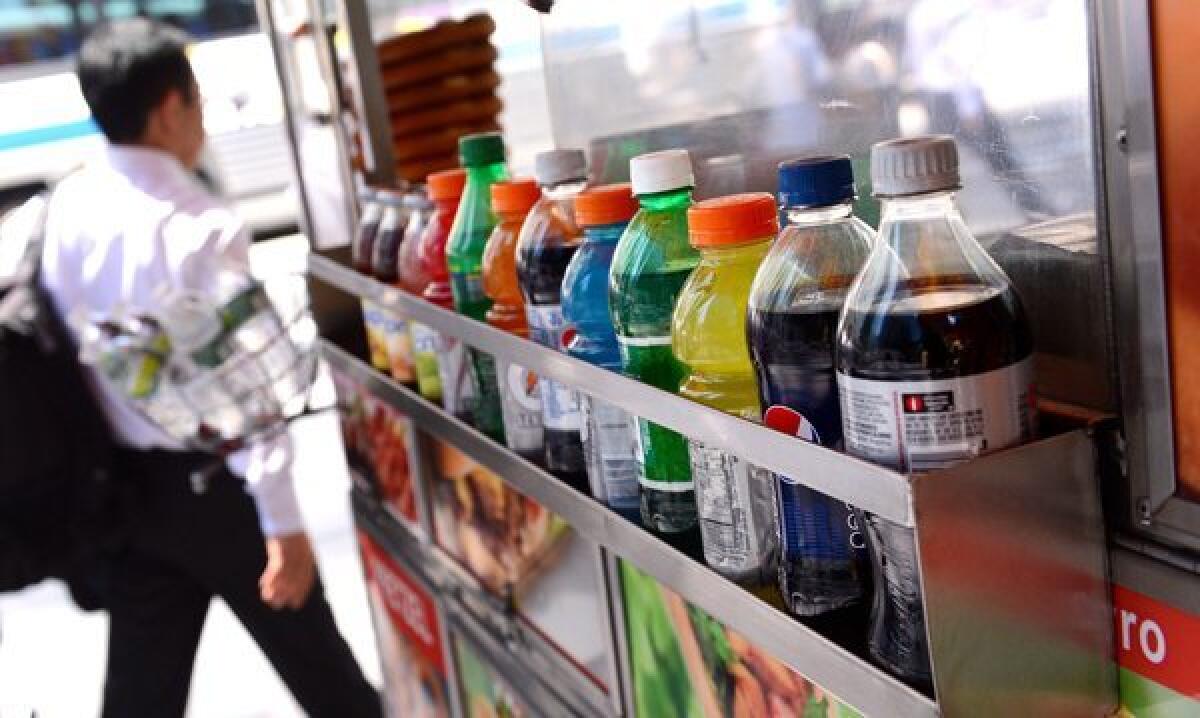 Some sugary drinks are displayed on a street cart in New York City.