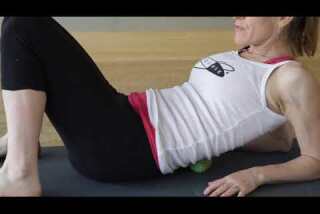 Try This: Ease lower back pain with a roll on yoga therapy balls