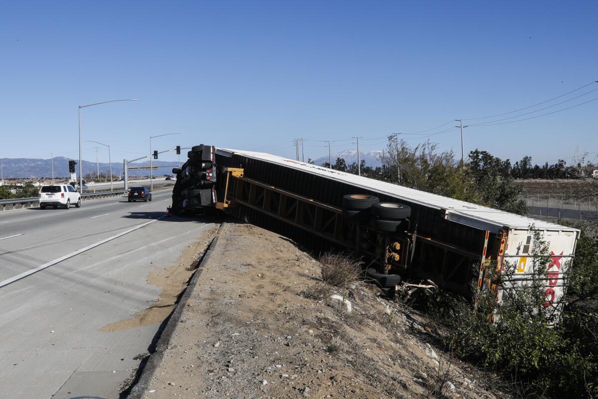 A big rig lies on its side