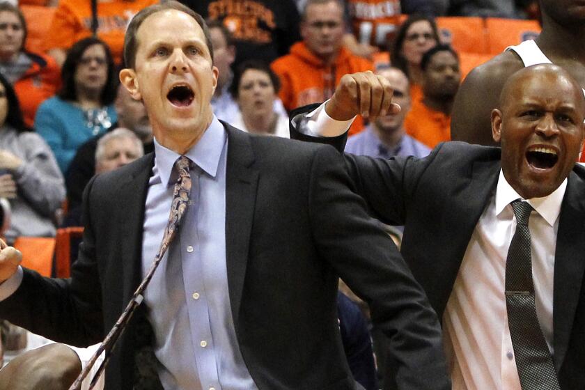 Mike Hopkins, left, and fellow assistant coach Adrian Autry celebrate in the final seconds of Syracuse's win over Wake Forest on Jan. 24.