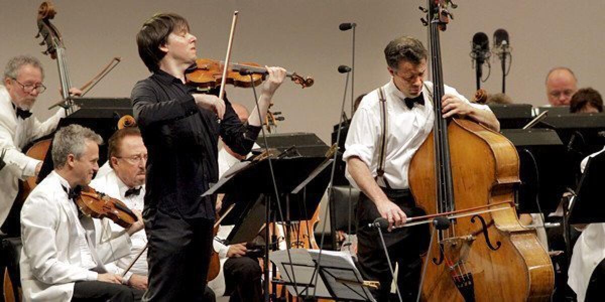 Joshua Bell (left) joins classical/bluegrass bassist Edgar Meyer in Meyer's Double Concerto for violin and bass with French music director, Ludovic Morlot conducting.