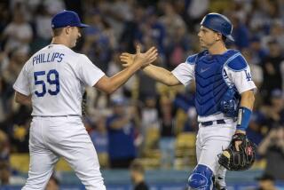 Los Angeles Dodgers relief pitcher Evan Phillips, left, celebrates with catcher Will Smith.