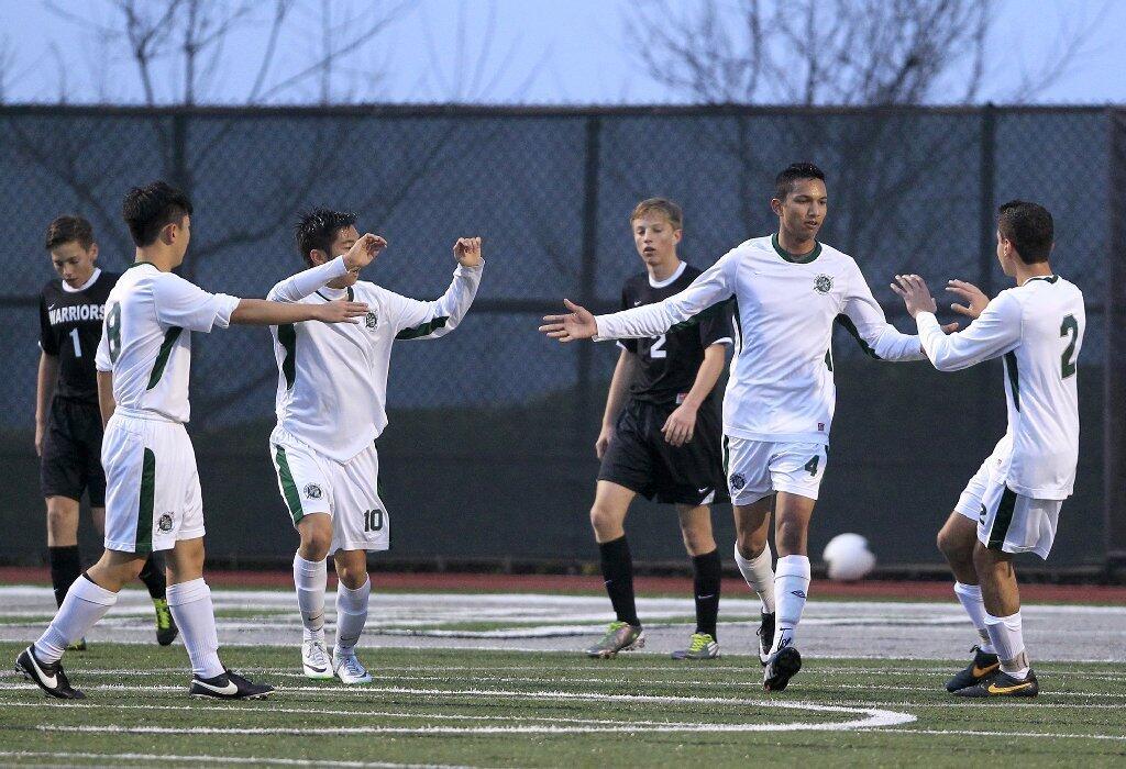 Sage Hill School's Dakshin Jandhyala, second from right, celebrates with teammates Danny Lee, Anthony Gil and Kavi Sakraney, foreground from left, after Jandhyala scored a goal during the first half against Brethren Christian in an Academy League game on Thursday.