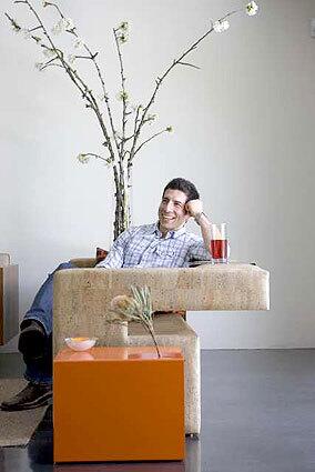 COMFY CORK: Reza Feiz, relaxes on a couch inspired by cantilevered homes off Mulholland Drive.