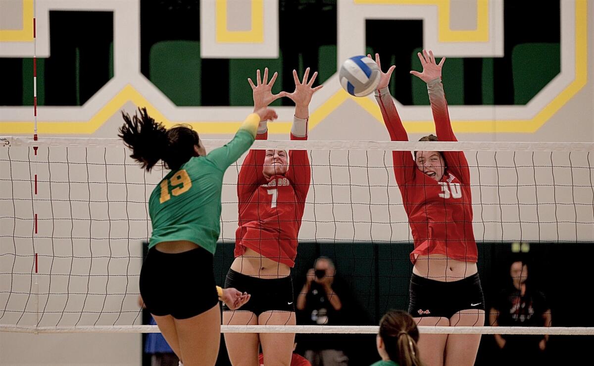 Mira Costa’s Simone Roslon is blocked by Mater Dei’s Julia Kakkis and Emma Kingston in a nonleague match Aug. 29.