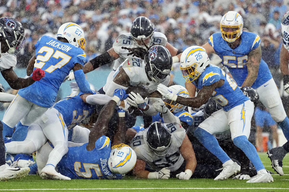 Titans running back Derrick Henry is tackled during overtime of Sunday's game.