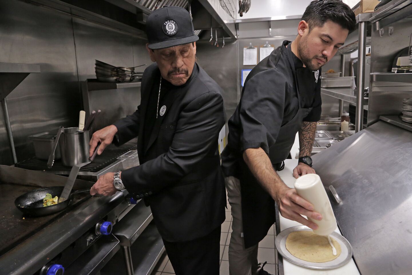 Actor Danny Trejo, left, and chef John-Carlos Kuramoto cook up their vegan cauliflower taco at Trejo's Cantina in Hollywood.
