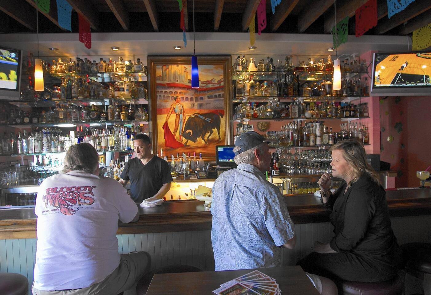 Chatting up patrons at the El Matador restaurant bar