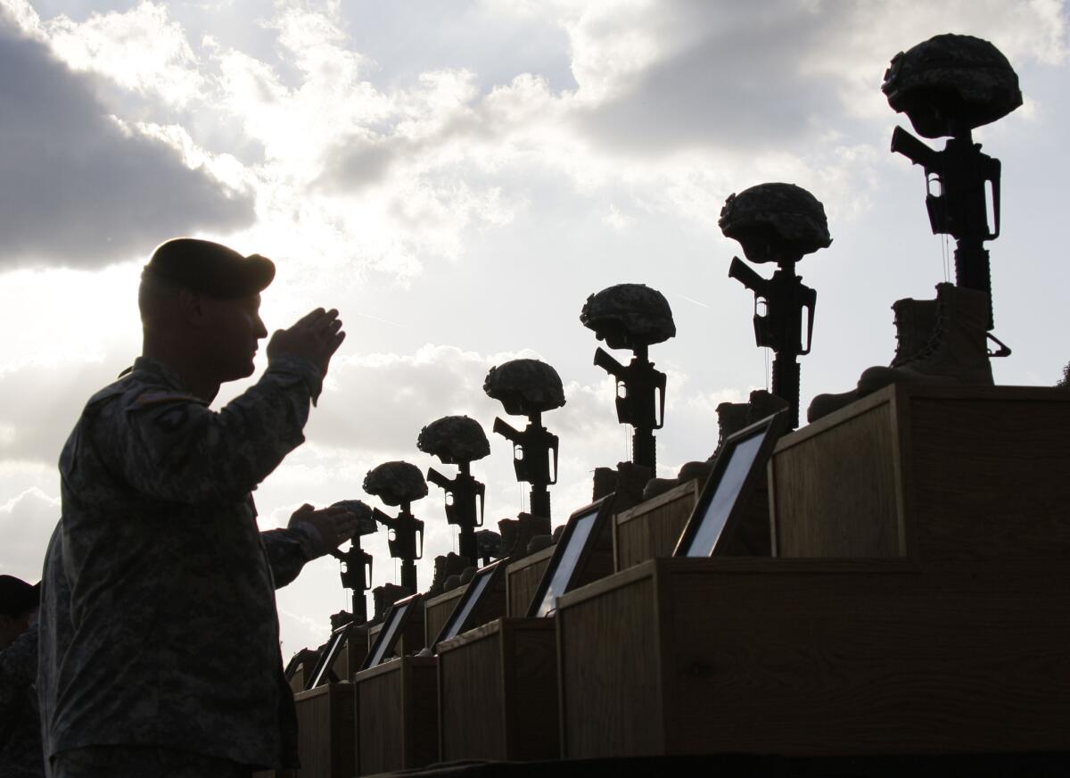 Soldiers honor victims of the Ft. Hood shooting at a memorial service on the Texas base in 2009. Victims will receive Purple Hearts in a ceremony at the military post Friday.