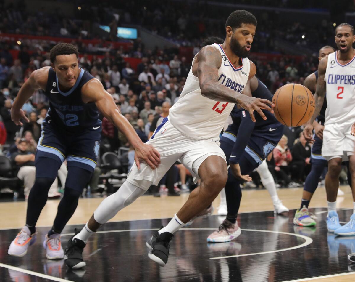 Grizzlies' Desmond Bane, left, grabs Paul George who runs out the clock in the Clippers come-from-behind win.