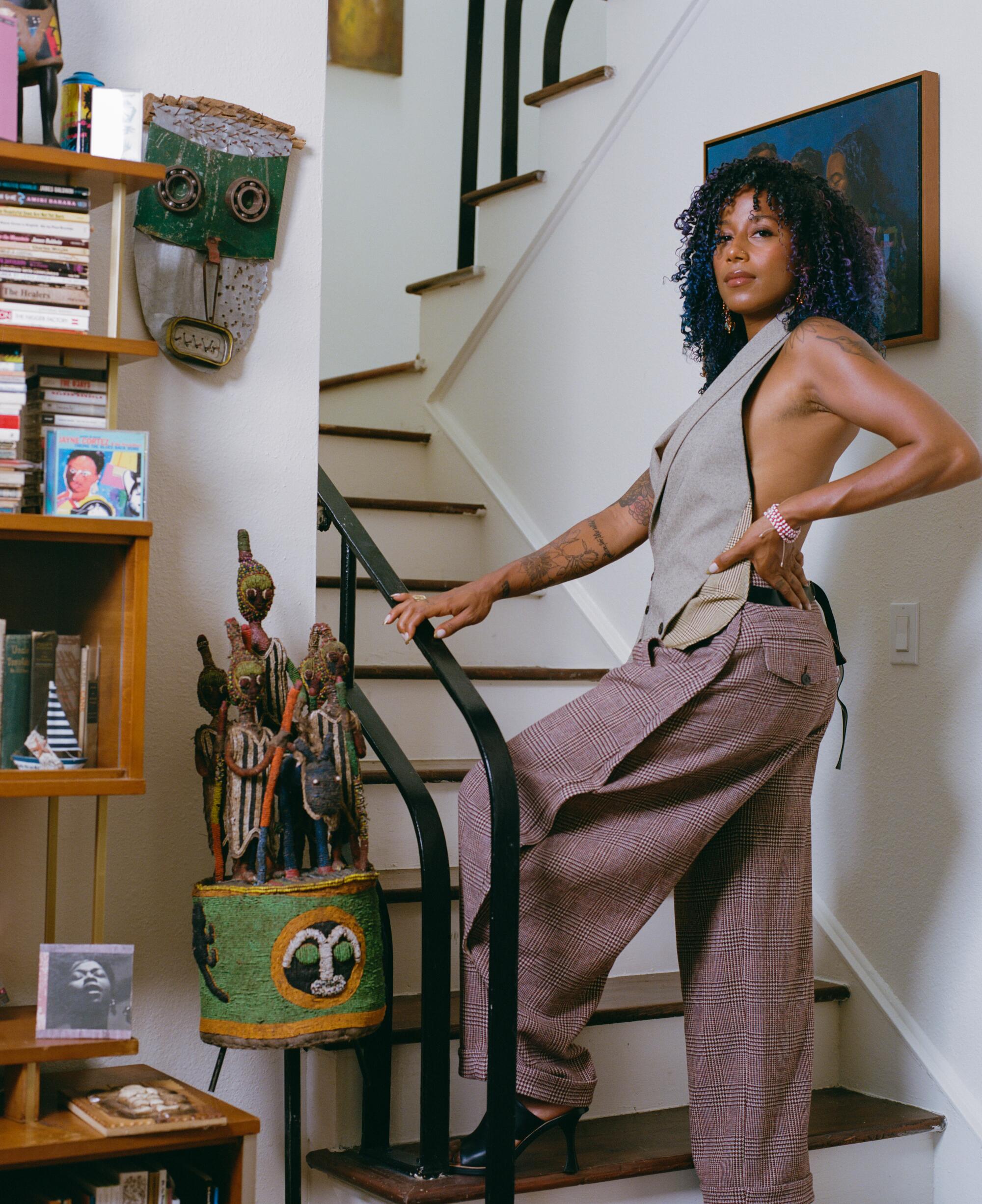 aja monet stands on a staircase.