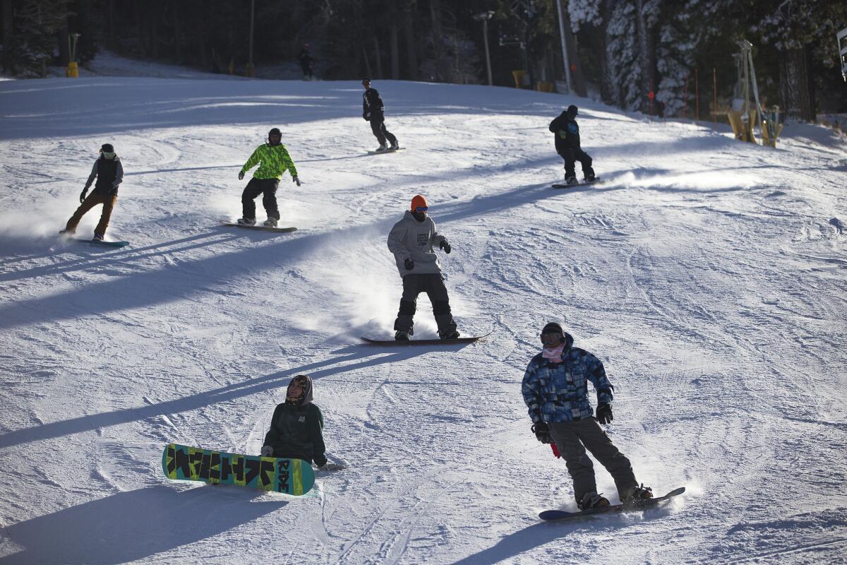 Snowboarders glide down a hill at Mountain High Ski Resort. The temperature was 28 degrees in the afternoon on Saturday, Nov. 28.