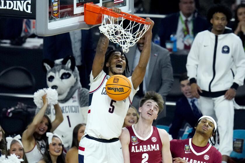 UConn guard Stephon Castle (5) dunks over Alabama forward Grant Nelson (2) during the second half.