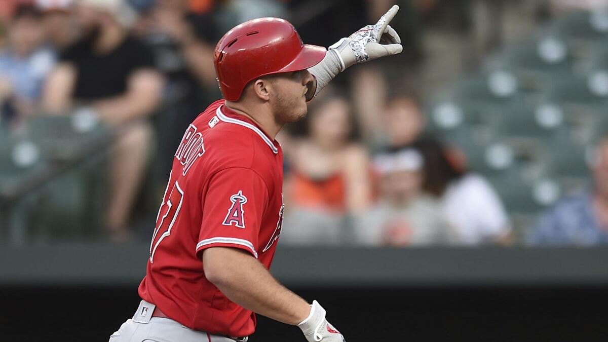 Mike Trout gestures after hitting a solo home run against the Baltimore Orioles in the first inning.