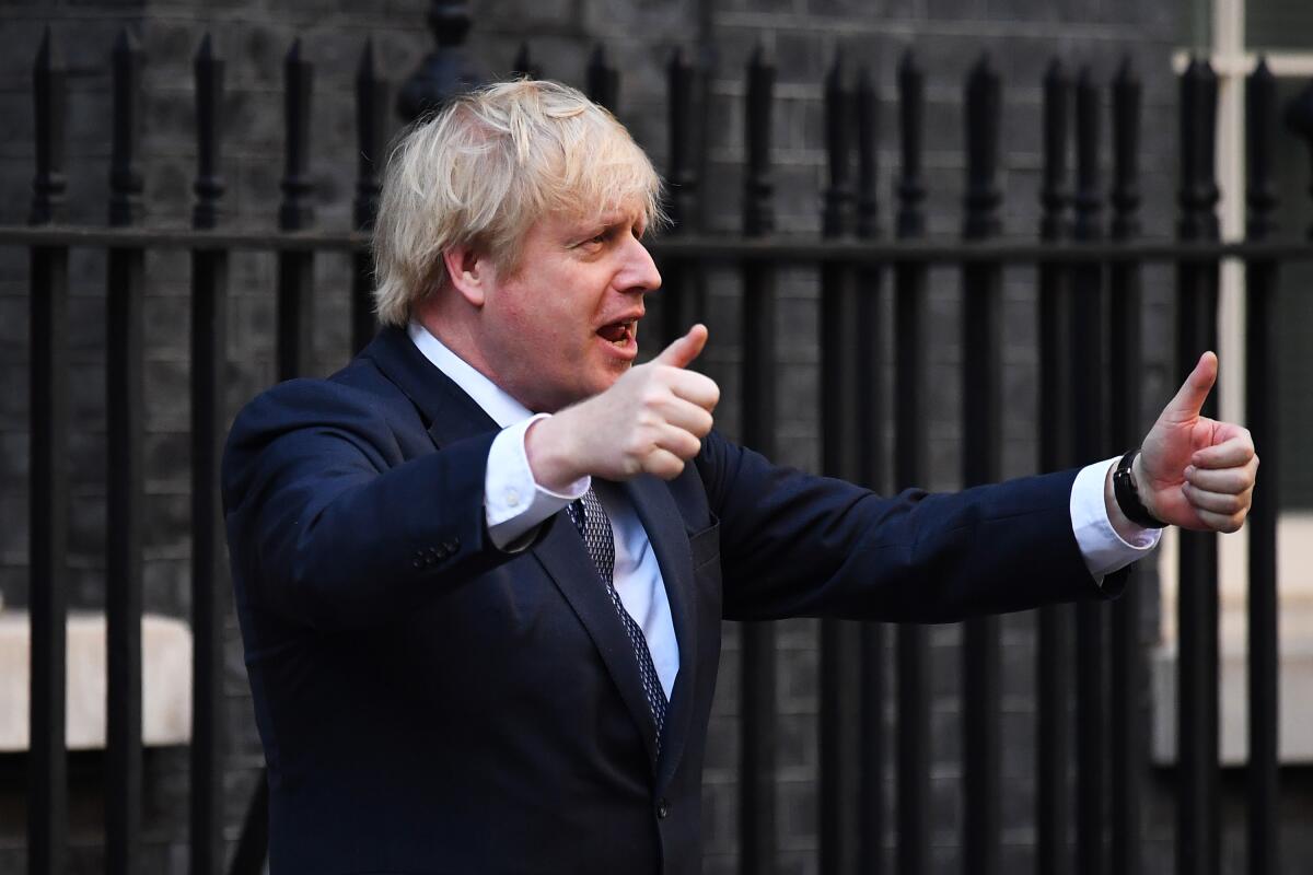 British Prime Minister Boris Johnson applauds essential workers