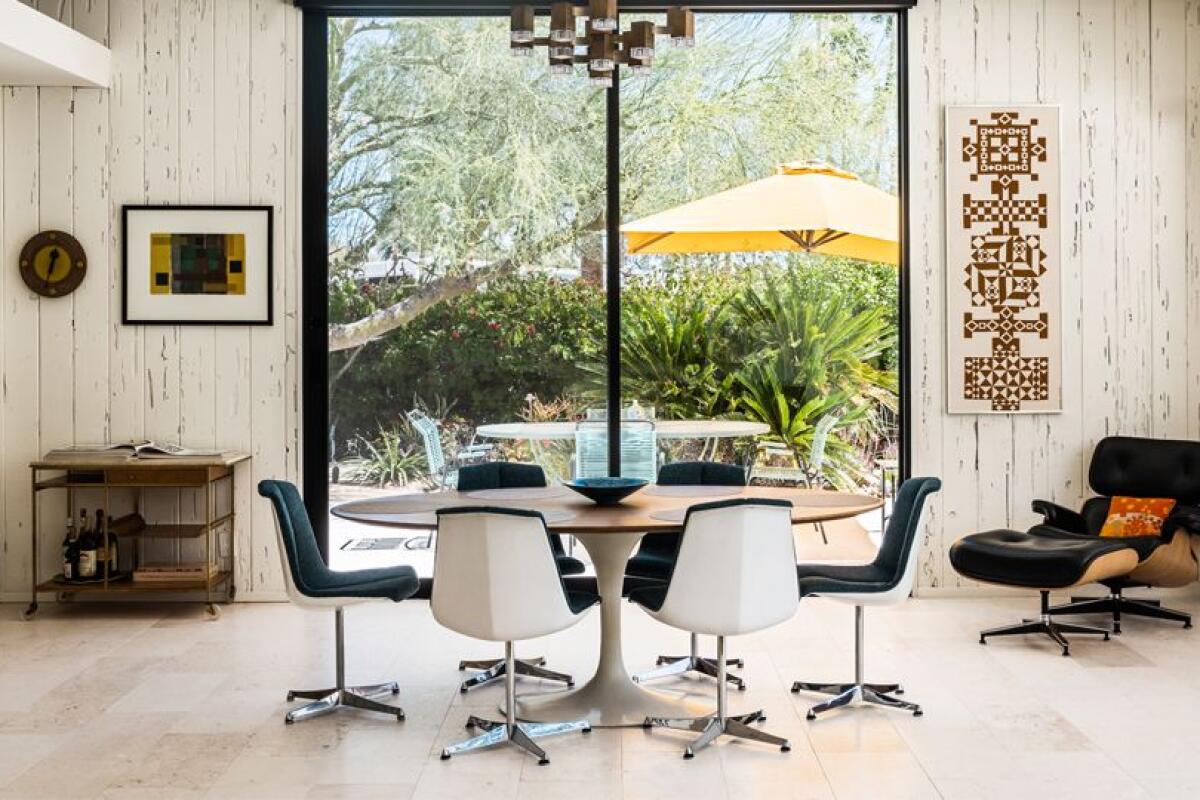 A dining room overlooking a window and yard.