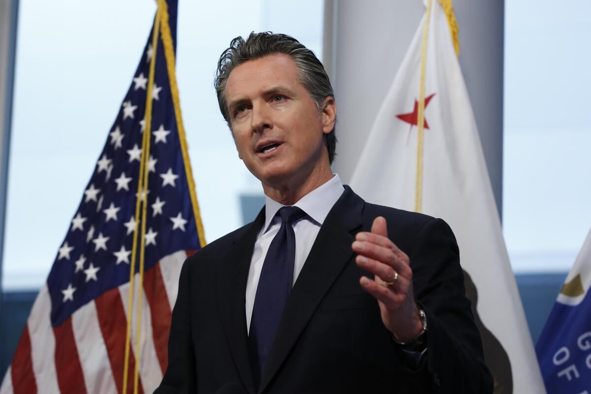 Gov. Gavin Newsom, seen giving a coronavirus briefing on March 30, has included marijuana shops on the list of essential businesses allowed to stay open.