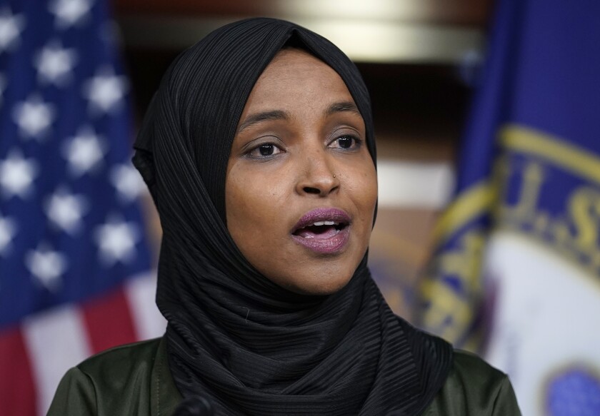 FILE - Rep. Ilhan Omar, D-Minn., speaks to reporters in the wake of anti-Islamic comments made by Rep. Lauren Boebert, R-Colo., who likened Omar to a bomb-carrying terrorist, during a news conference at the Capitol in Washington, Nov. 30, 2021. The House has taken the first formal response to Republican Rep. Lauren Boebert's anti-Muslim remarks by passing a bill to tackle Islamophobia worldwide. (AP Photo/J. Scott Applewhite, File)