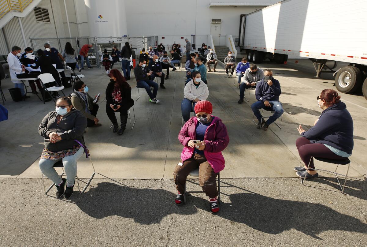 Claudia Alvarado, center, a worker at the My/Mochi plant in Vernon waits for observation 