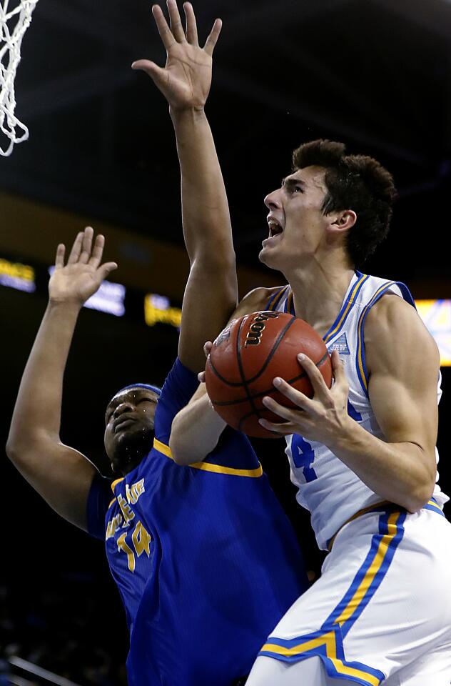 UCLA guard Jaime Jaquez Jr. scores a basket as he's fouled by San Jose State's Samuel Japhet-Mathias.
