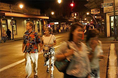 The First Friday street fair in Chinatown lures crowds to see the many art galleries that stay open late for the event. Street musicians perform as visitors poke into shops and restaurants.