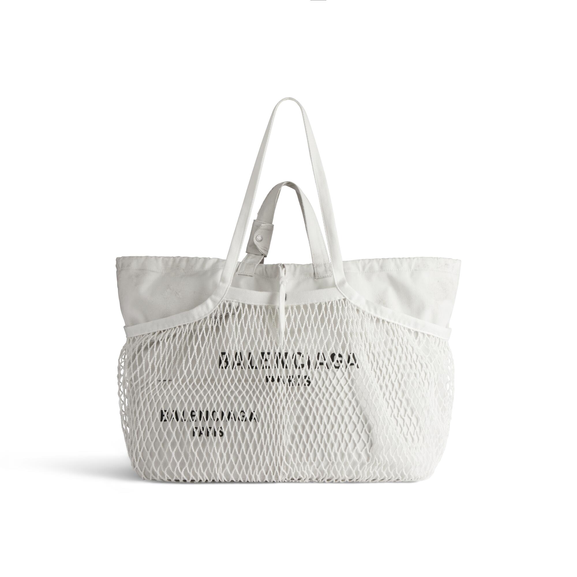 a white Balenciaga tote bag