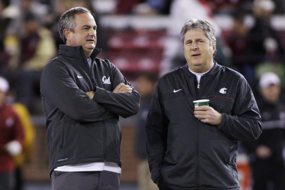Sonny Dykes, left, and Mike Leach talk before a game between California and Washington State in November 2016.